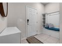 Welcoming entryway features a convenient bench with storage and a decorative mirror, enhancing functionality at 301 Jetty Way, Davenport, FL 33897