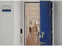 Entryway featuring a blue door into a tiled hall with an open view of the living room and window at 3191 Paradox Cir # 401, Kissimmee, FL 34746