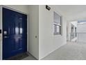 Apartment entrance featuring a dark blue door with a smart lock and a window to the right at 3191 Paradox Cir # 401, Kissimmee, FL 34746