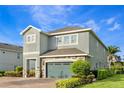 Two-story house with well-manicured landscaping and a stone-accented two-car garage at 321 Falls Dr, Kissimmee, FL 34747