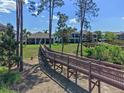 Beautiful backyard and wooden bridge access to the community amenities, offering privacy and easy access to recreation at 3456 Shallow Cove Ln, Clermont, FL 34711