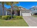 Charming single-Gathering home with well-manicured lawn, lovely landscaping and a welcoming covered porch at 3456 Shallow Cove Ln, Clermont, FL 34711