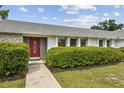 Front door to a charming single Gathering home surrounded by lush, green landscaping at 3994 Irma Shores Dr, Orlando, FL 32817