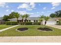 Charming single Gathering home with a well-manicured lawn and mature landscaping, including palm trees at 3994 Irma Shores Dr, Orlando, FL 32817