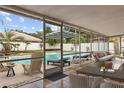 Covered patio with an outdoor lounge area overlooking a pool with chaise lounges at 3994 Irma Shores Dr, Orlando, FL 32817