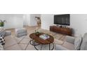Sun-filled living room with stylish furniture, modern decor, and wood-look floors at 500 Newell Hill Rd # 113A, Leesburg, FL 34748
