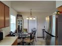 Cozy dining area with a glass table, complemented by stainless steel appliances in the adjacent kitchen at 509 Dorothy Cir, Eustis, FL 32726