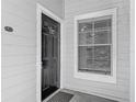 Close-up of a condo's front door with a 'welcome' sign and secure entry at 5144 City St # 211, Orlando, FL 32839