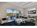 Spacious living room features a large glass window, a leather couch, and modern decor at 748 Desert Mountain Ct, Reunion, FL 34747