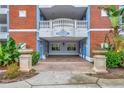 Covered entrance with brick accents, elegant columns, and address displayed at 7652 Whisper Way # 301, Reunion, FL 34747