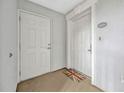 Entryway with two white doors, a welcome mat, and neutral walls at 7652 Whisper Way # 301, Reunion, FL 34747