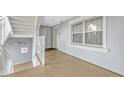 Hallway with stairs, white railings, and a large window for natural light at 7652 Whisper Way # 301, Reunion, FL 34747