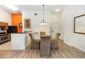Well-lit dining space showcasing stylish flooring, an elegant chandelier, and providing seamless transition into kitchen at 8100 Poinciana Blvd # 2109, Orlando, FL 32821