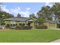 Charming one-story home featuring a well-manicured lawn, and attached two-car garage at 817 Benton Lake S Dr, Deland, FL 32724