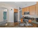 Modern kitchen features stainless steel appliances, granite countertops and stylish tile floors at 817 Benton Lake S Dr, Deland, FL 32724