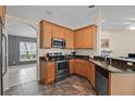 Modern kitchen features stainless steel appliances, granite countertops and stylish tile floors at 817 Benton Lake S Dr, Deland, FL 32724