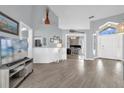 Open-concept living area with hardwood floors, neutral paint, and lots of natural light at 1004 Moccasin Run Rd, Oviedo, FL 32765