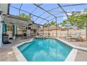 Screened-in pool area with a hot tub and covered patio for outdoor relaxation at 1004 Moccasin Run Rd, Oviedo, FL 32765