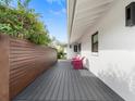 Stylish outdoor area with a wooden deck, privacy fence, and comfortable seating at 113 Tangelo Ct, Maitland, FL 32751