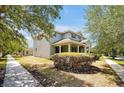Side view of a charming two-story home with well-maintained landscaping and a spacious front yard at 14522 Old Thicket Trace, Winter Garden, FL 34787