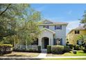 Charming two-story home featuring blue shutters, a covered porch, and well-maintained landscaping at 14522 Old Thicket Trace, Winter Garden, FL 34787