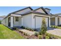 Beautifully landscaped front exterior featuring a paver driveway and walkway at 1900 Archer Dr, Minneola, FL 34715