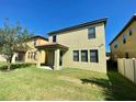 The home features a spacious backyard with healthy green grass and a covered patio at 191 Chickasaw Berry Rd, Ocoee, FL 34761