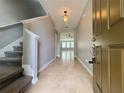 Inviting foyer features tile flooring, staircase and leads to the living area at 191 Chickasaw Berry Rd, Ocoee, FL 34761