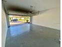Spacious two-car garage with an open door revealing a brick paved driveway at 191 Chickasaw Berry Rd, Ocoee, FL 34761
