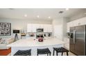 Modern kitchen featuring stainless steel appliances, a large island, and white cabinetry at 2572 Penguin Blvd, Davenport, FL 33837
