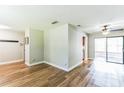 Spacious living area featuring beautiful hardwood floors, ceiling fan and access to additional rooms at 2839 Tamarack Trl, Apopka, FL 32703