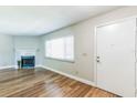 Inviting living room featuring hardwood floors, fireplace, and a bright window offering natural light at 2839 Tamarack Trl, Apopka, FL 32703