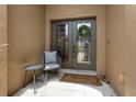 Charming front entrance featuring a decorative glass door, welcome mat, and a cozy seating arrangement at 36813 Barrington Dr, Eustis, FL 32736