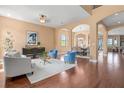 Spacious living room with wood floors, stylish furnishings, and arched doorways leading to other rooms at 36813 Barrington Dr, Eustis, FL 32736