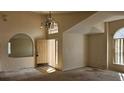 Spacious entryway with high ceilings, arched window, chandelier, and a view of the adjacent rooms at 4526 Oakton Dr, Orlando, FL 32818