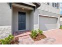 A close up of a charming front entry featuring a brick walkway and manicured landscaping at 4705 Jasmine Cir, Leesburg, FL 34748