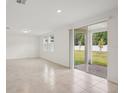 Open concept living room with tile flooring, recessed lighting, and sliding glass doors leading to the patio at 4721 Jasmine Cir, Leesburg, FL 34748