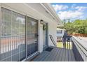 Condo entryway with sliding glass door and storm door leading to a private balcony at 4870 Conway Rd # 106, Orlando, FL 32812