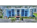 Beautiful condo building with many balconies, parking, and lush landscaping at 5300 S Atlantic Ave # 2-505, New Smyrna Beach, FL 32169