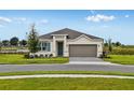 Charming single-Gathering home with a two-car garage, well-maintained lawn, and beautiful landscaping at 531 Silver Palm Dr, Haines City, FL 33844