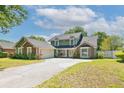 Lovely two-story home with a charming exterior, lush landscaping, and inviting curb appeal at 5330 Keswick Ct, Orlando, FL 32812