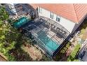 Backyard pool with screen enclosure and outdoor seating offers private relaxation at 5416 Solterra Cir, Davenport, FL 33837