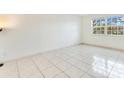 An airy bedroom with large window and tile floors at 5763 Saint Christopher Dr # 55, Orlando, FL 32822