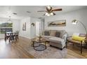 Cozy living room with wood floors, a comfortable sectional sofa, and contemporary decor at 5831 Nw 58Th Ter, Ocala, FL 34482