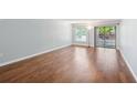 Bright living room with wood floors and a sliding glass door allowing access to the porch at 610 Cranes Way # 207, Altamonte Springs, FL 32701