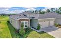 Charming one-story home featuring stone accents, manicured landscaping, and a two-car attached garage at 7563 Sw 78Th Ter, Ocala, FL 34481
