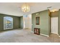 Open entryway featuring neutral walls, chandelier, and natural light from arched window at 7718 Cafaro Dr, Orlando, FL 32818
