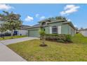 Green single-Gathering home featuring well-manicured lawn and paved driveway at 7718 Cafaro Dr, Orlando, FL 32818