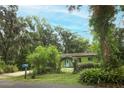 Home exterior with lush landscaping, inviting curb appeal, and a tranquil setting at 7761 Hillcrest Ter, Orlando, FL 32810