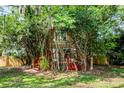 Charming home exterior with a front deck and lush landscaping providing privacy at 7807 Napoleon St, Orlando, FL 32825